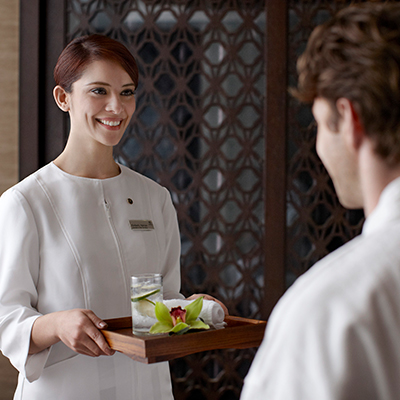 A Sheraton associate smiling at a guest.
